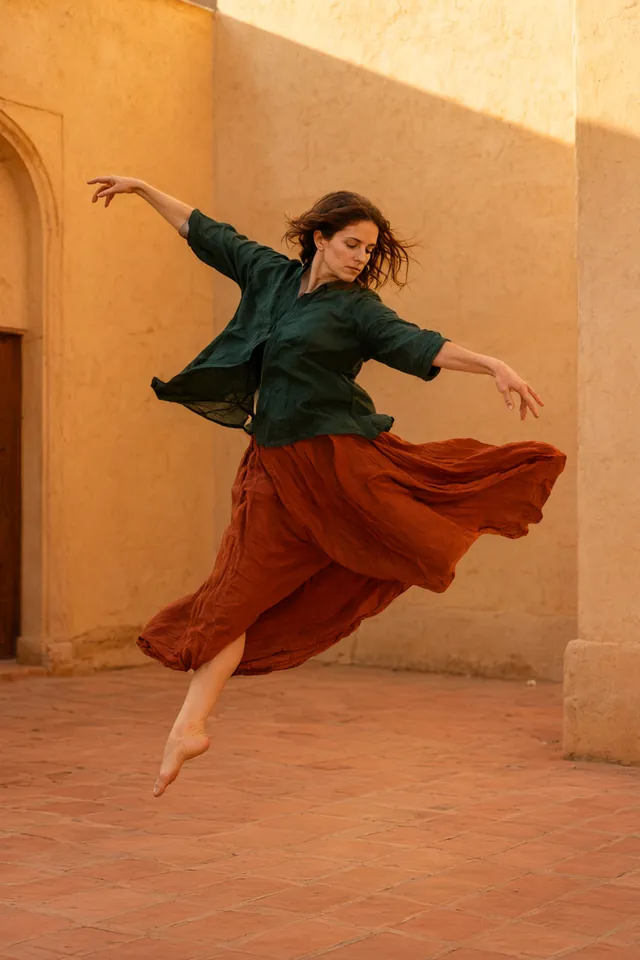 Dancer leaping in a terracotta courtyard